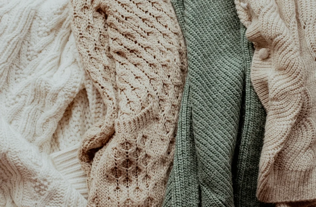 Cable knit pullover sweater textures showing different stitch structures and yarn effects