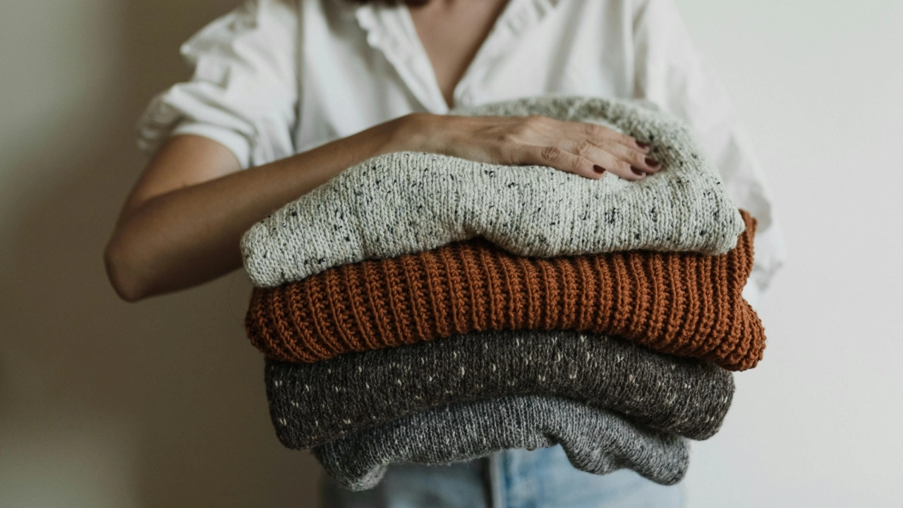 Folded pullover sweaters showing finished knitwear styles for development and approval