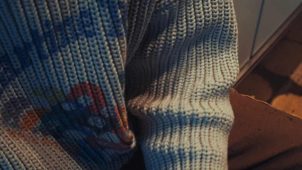 Close-up rib knit texture detail for cable knit zip up sweater fabric development