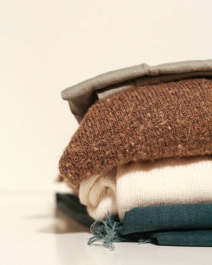Stacked wool knitwear and cashmere sweater fabrics for garment weight and retail price comparison