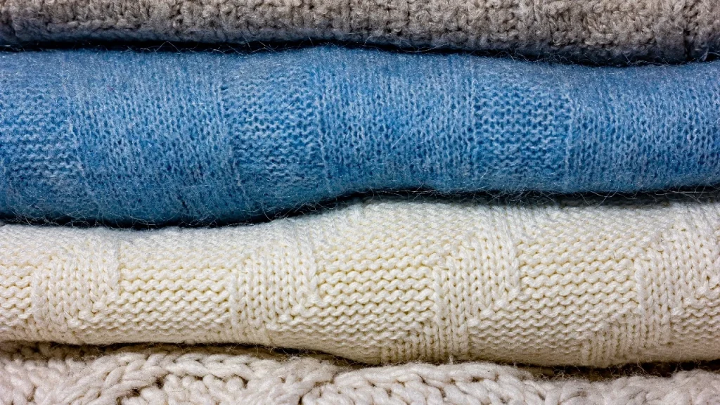 Close-up of wool knitwear surface texture showing fiber behavior and possible pilling risk