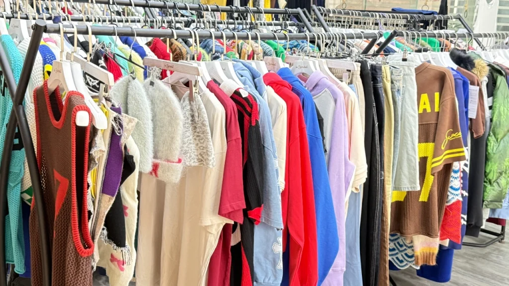 Clothing samples displayed on racks in a showroom, showing how Apparel manufacturers present styles and product options.