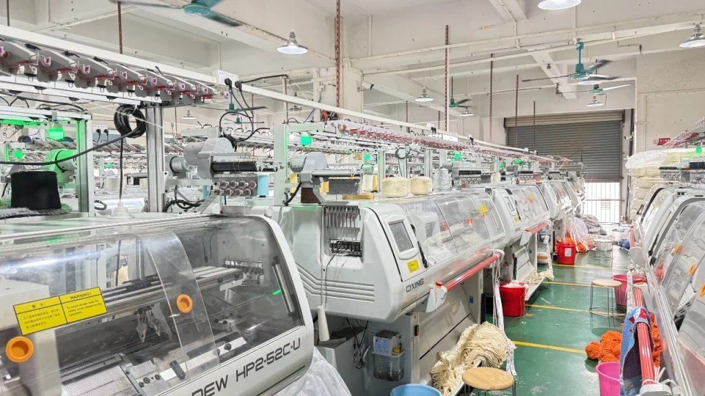 Knitting machines inside a production workshop used by Apparel manufacturers for garment development and bulk production.