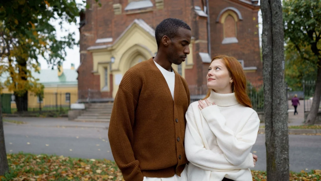 Cardigan Sweater outfits worn by a couple in an autumn outdoor setting.