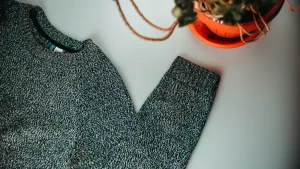 Flat lay knit sweater used by custom clothing manufacturers for knitwear development