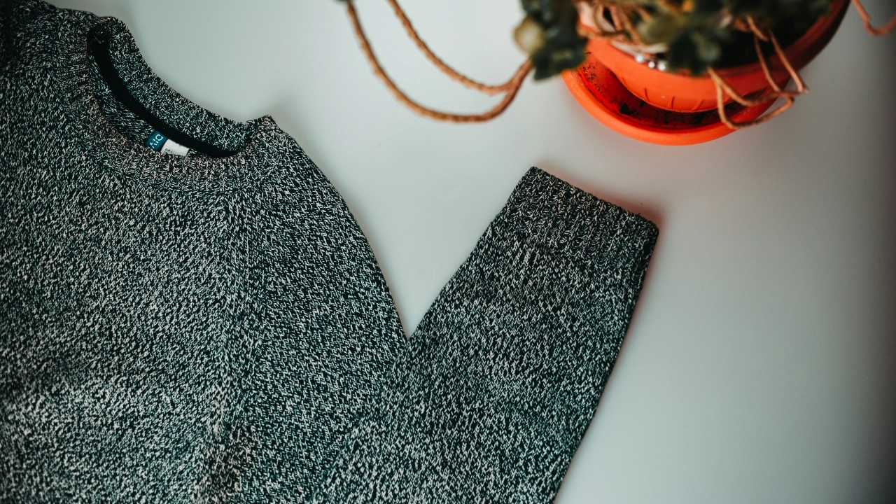 Flat lay knit sweater used by custom clothing manufacturers for knitwear development