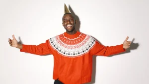 Man wearing a red patterned sweater with Fair Isle details for custom embroidered sweaters inspiration