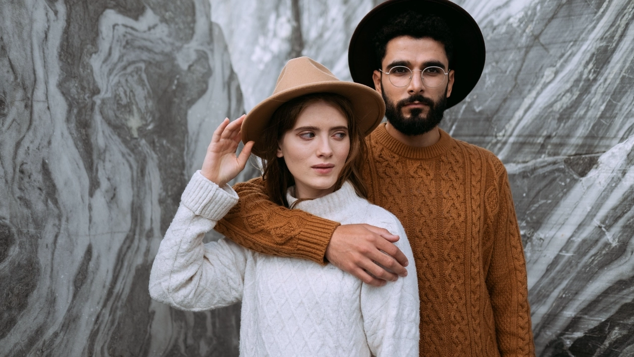 Custom Knit Sweaters cable knit styles worn by two models in outdoor setting.