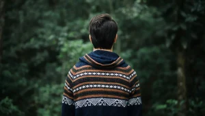 Grey knit zip up hoodie worn in an outdoor lifestyle setting