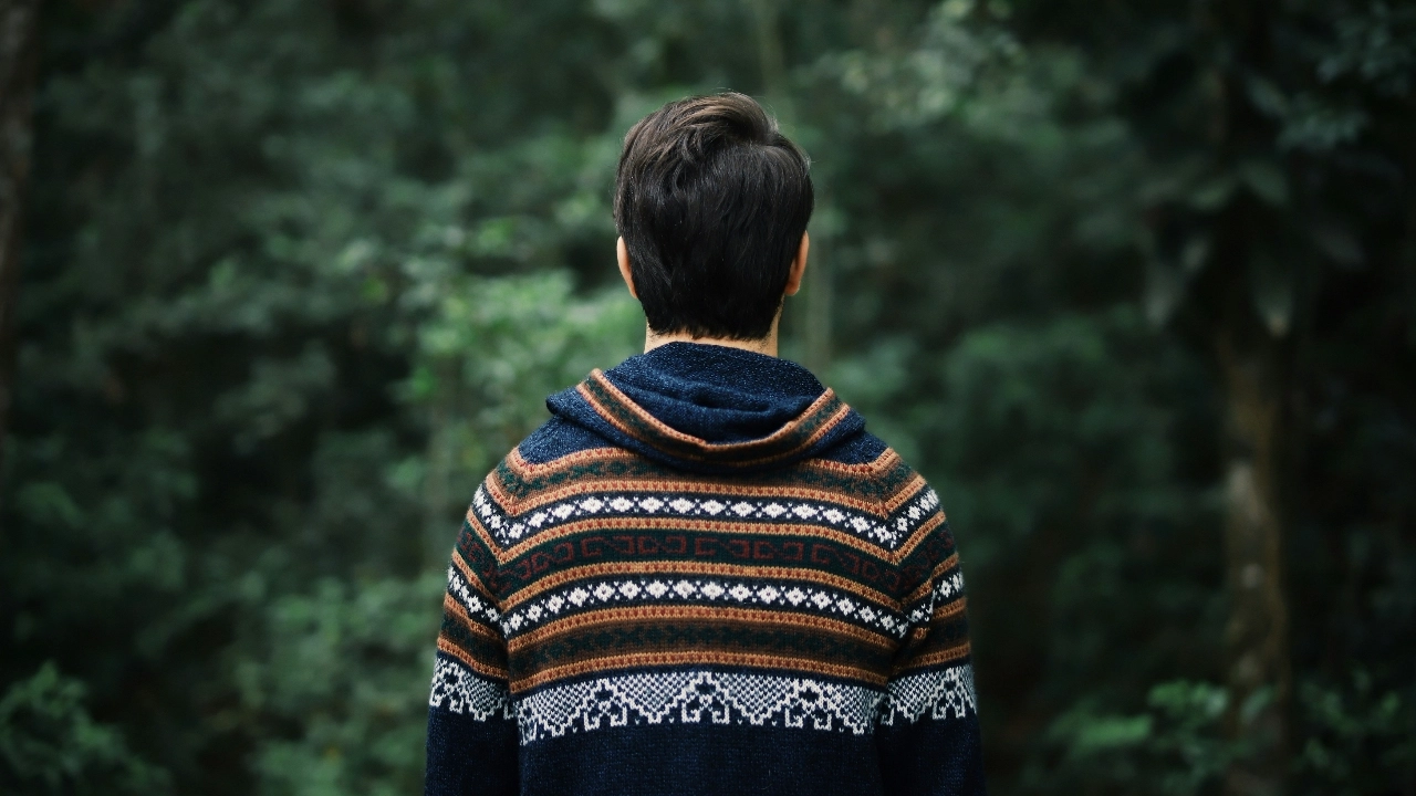 Grey knit zip up hoodie worn in an outdoor lifestyle setting