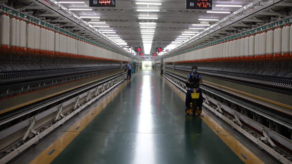 Large industrial spinning line inside a knitwear factory for bulk yarn production
