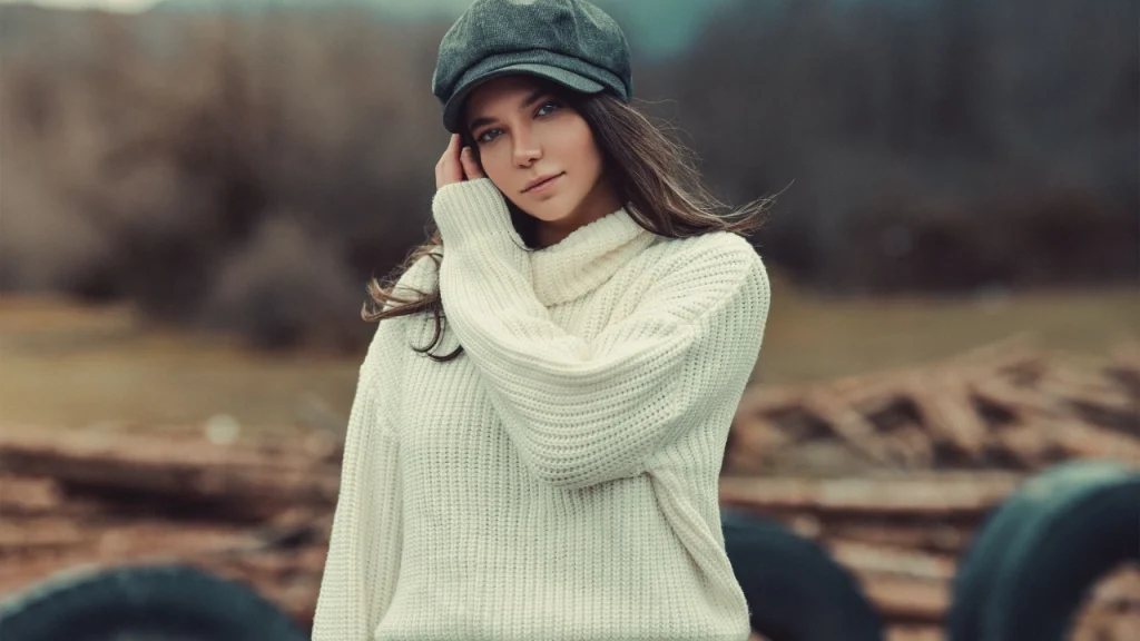 Knitwear Manufacturer cream turtleneck sweater styled outdoors with a casual winter look.
