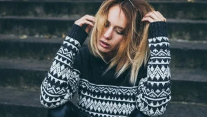 Woman wearing a black and white jacquard sweater for knitwear manufacturer design inspiration