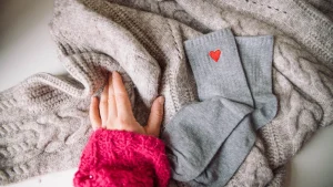 Knitwear flat lay with socks and textured sweater for private label styling