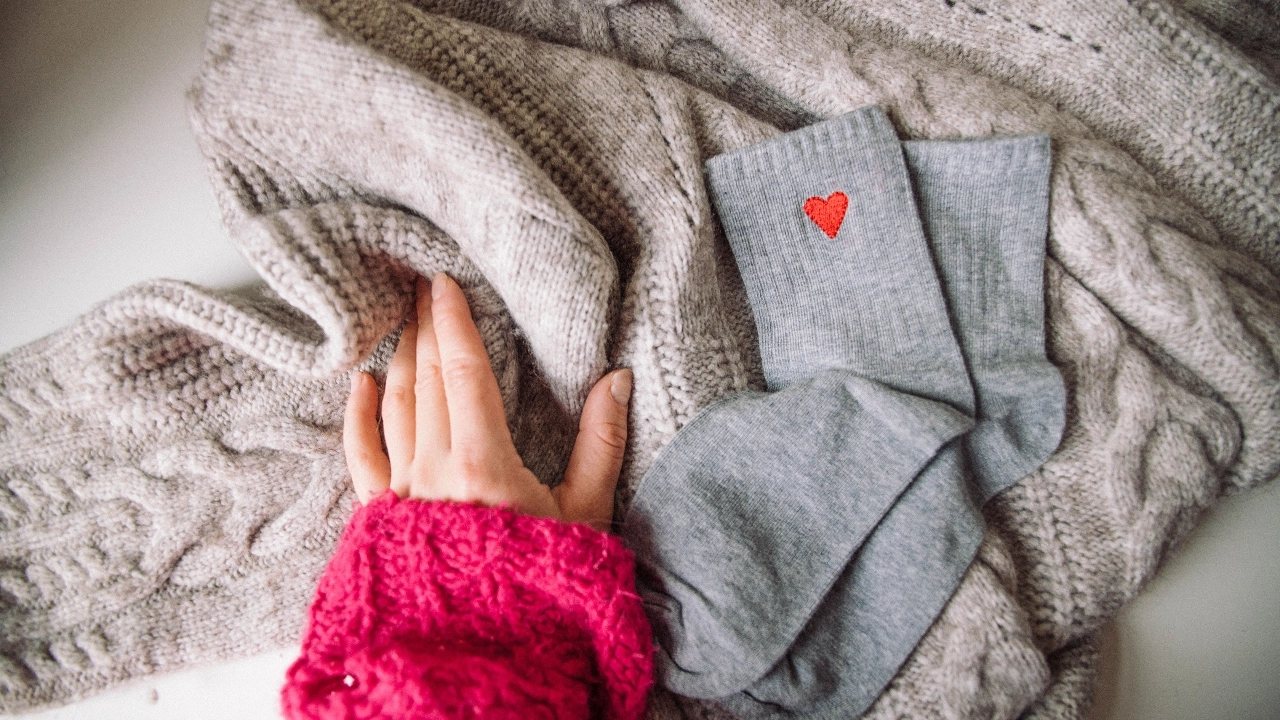 Knitwear flat lay with socks and textured sweater for private label styling