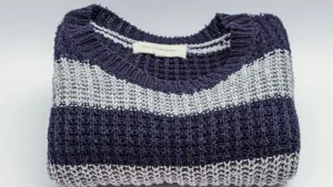 Folded striped sweater showing knit texture and private label knitwear presentation