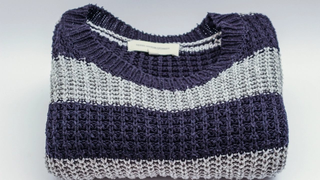 Folded striped sweater showing knit texture and private label knitwear presentation