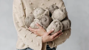 Woman holding yarn balls for private label knitwear material planning