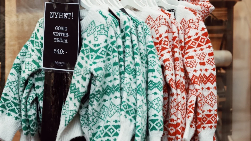 Sweater Factory patterned winter sweaters displayed on hangers for seasonal knitwear collections.