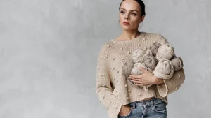 Sweater manufacturer model holding yarn balls for knitwear design and material development