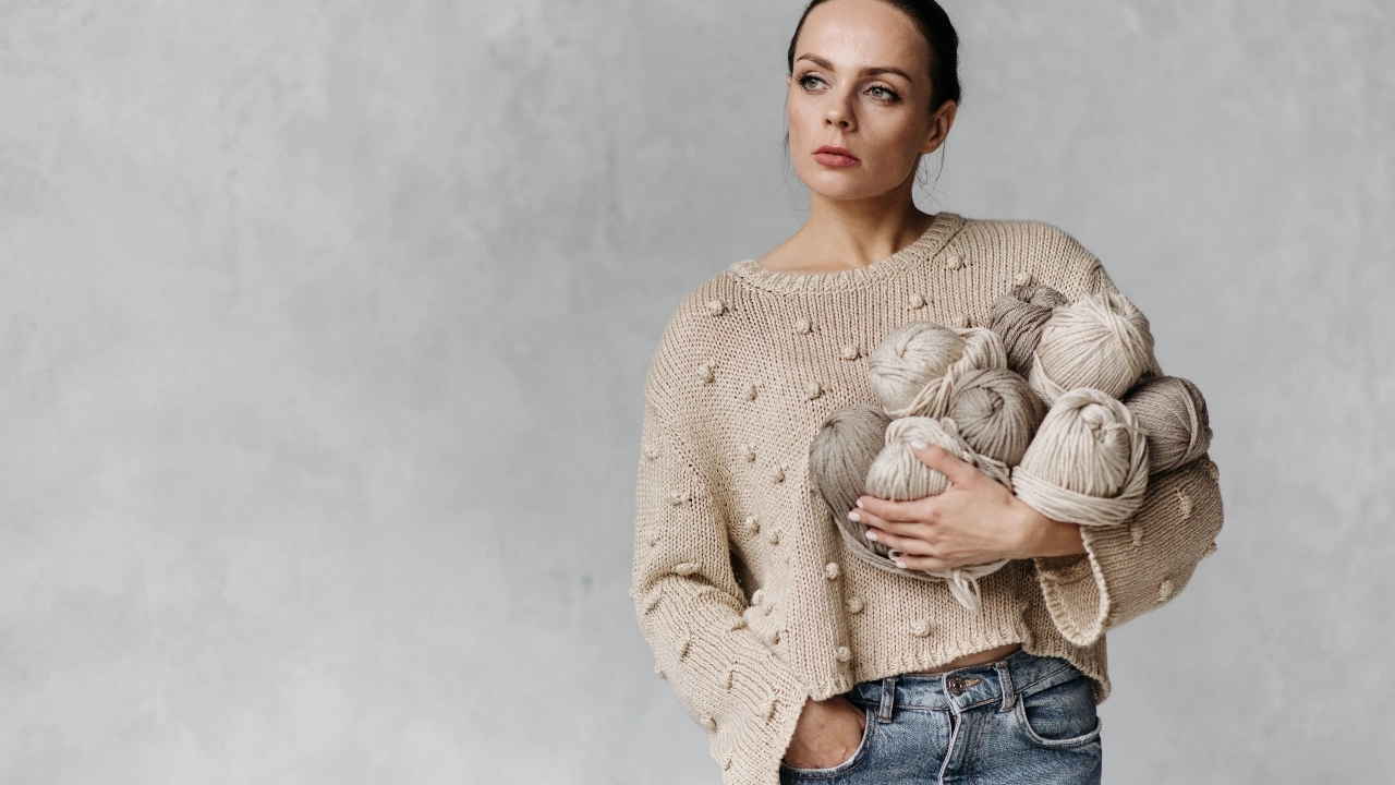 Sweater manufacturer model holding yarn balls for knitwear design and material development