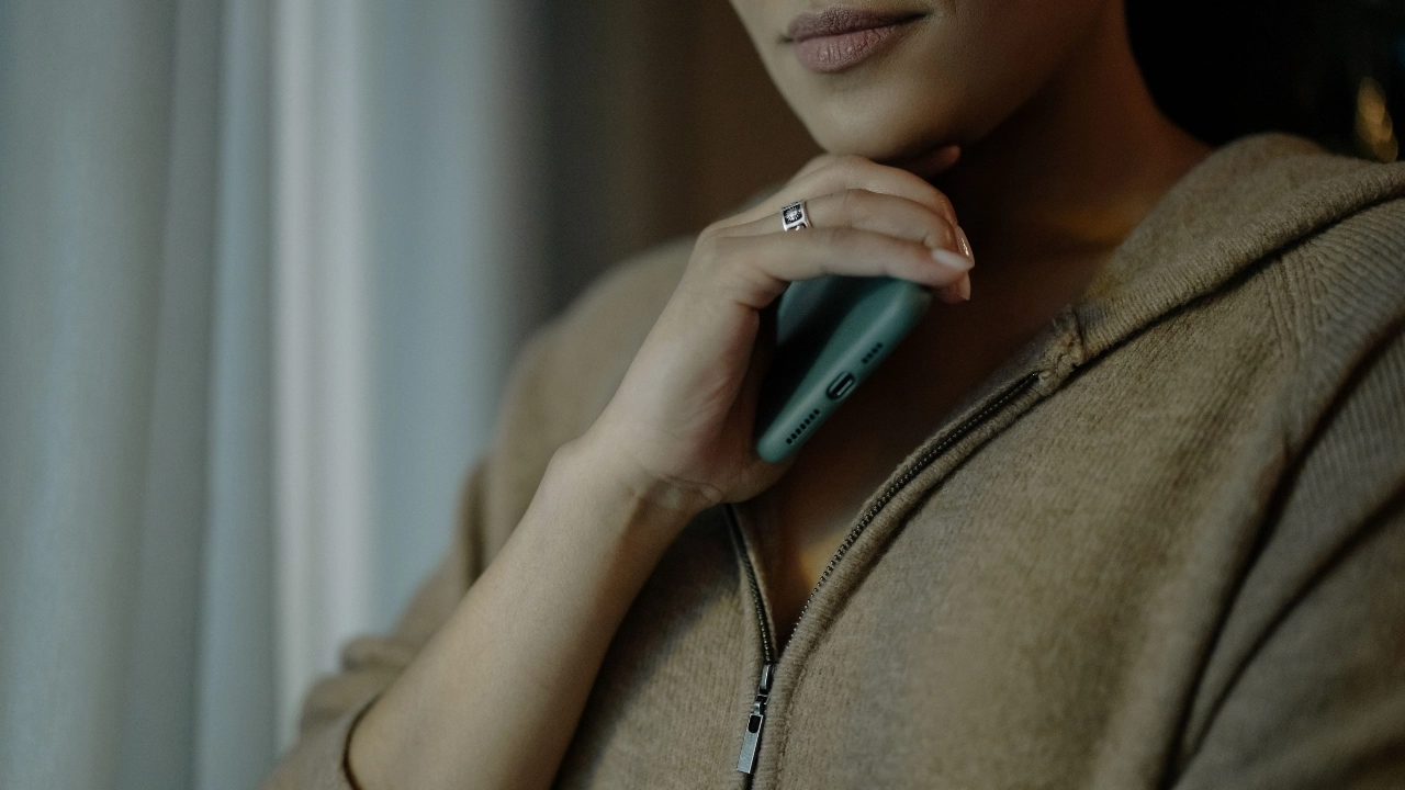 Zip cardigan close-up with soft neutral knit texture, front zipper, and relaxed loungewear styling.