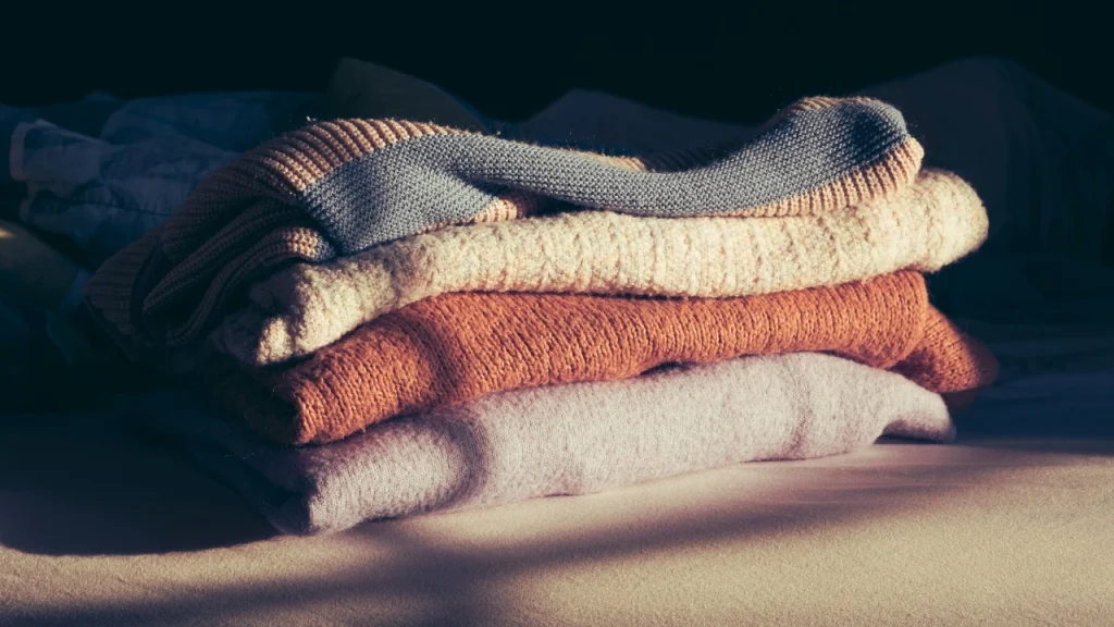 Folded Cotton Knitwear sweaters with multiple knit textures and seasonal colors.
