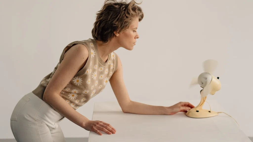 Woman wearing a floral jacquard Sleeveless Knitwear vest in a modern interior.