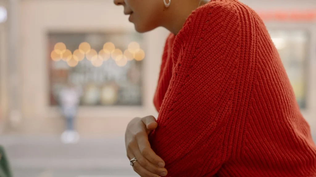 Close-up of a red Cotton Knitwear sweater highlighting knit texture and craftsmanship.
