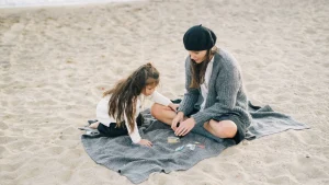Mother and daughter wearing cozy Cashmere Cardigan styles on the beach.