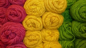 Bright pink, yellow, and green yarn balls arranged by Dye Lot color groups.