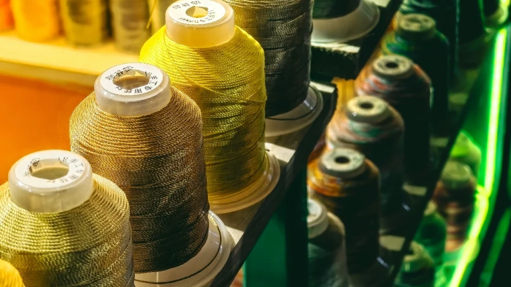 Metallic and colored thread cones prepared for Knitwear Production decoration work.