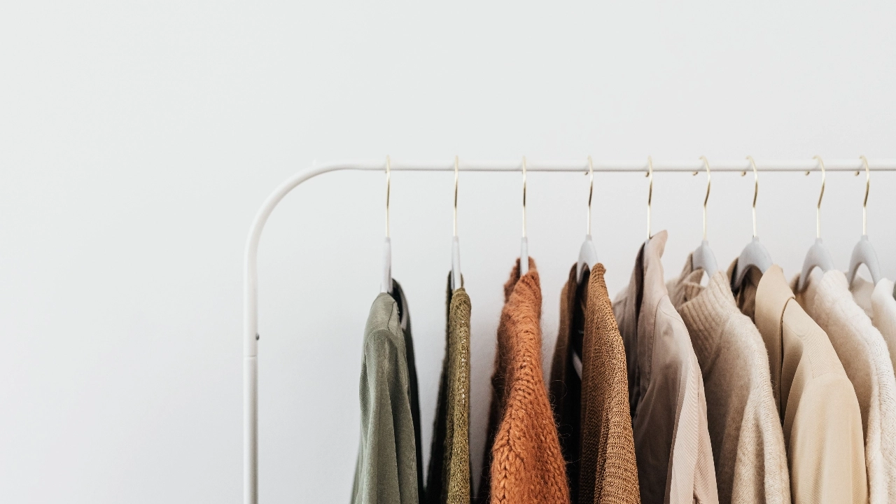 Knitwear garments hanging on a rack for knitwear supplier collection planning.
