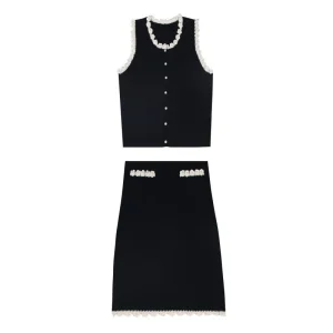 Black knit vest with trim detail and matching knit skirt, flat lay