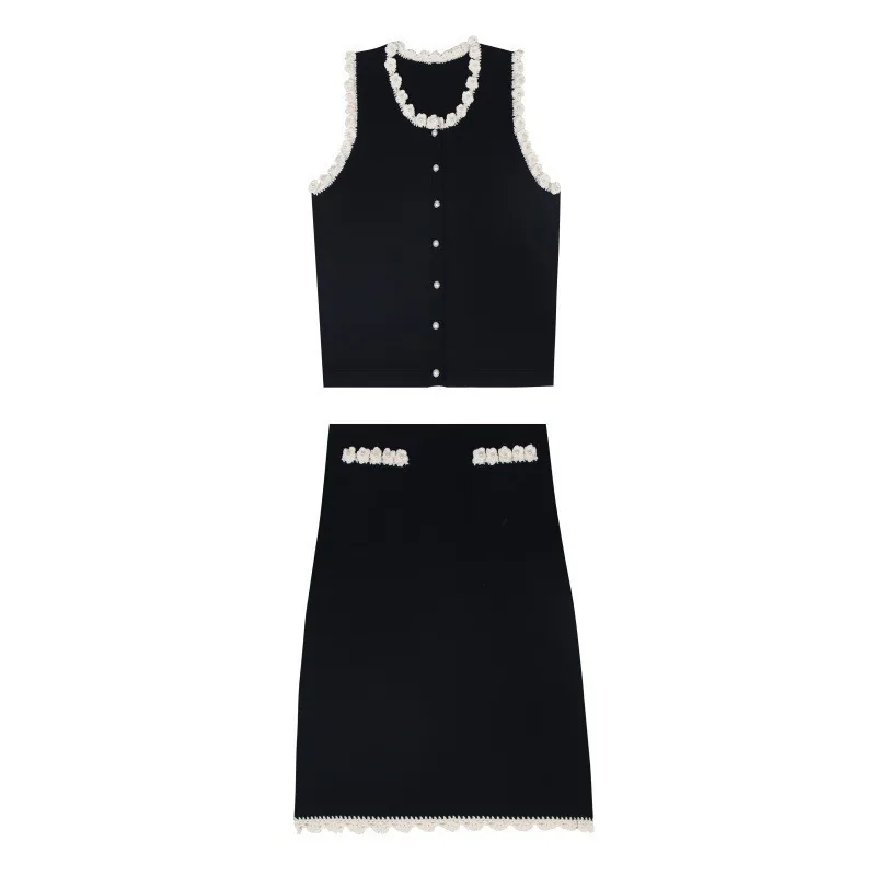 Black knit vest with trim detail and matching knit skirt, flat lay