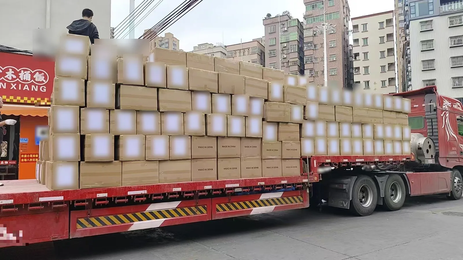 Bulk knitwear order packed in export cartons and loaded on a flatbed truck