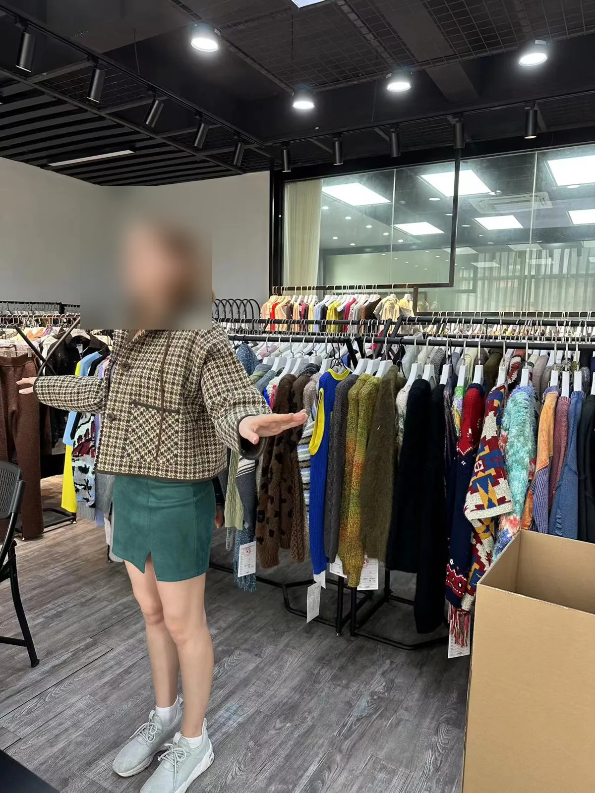 Buyer checking the fit of a knit jacket sample in the Cainan showroom