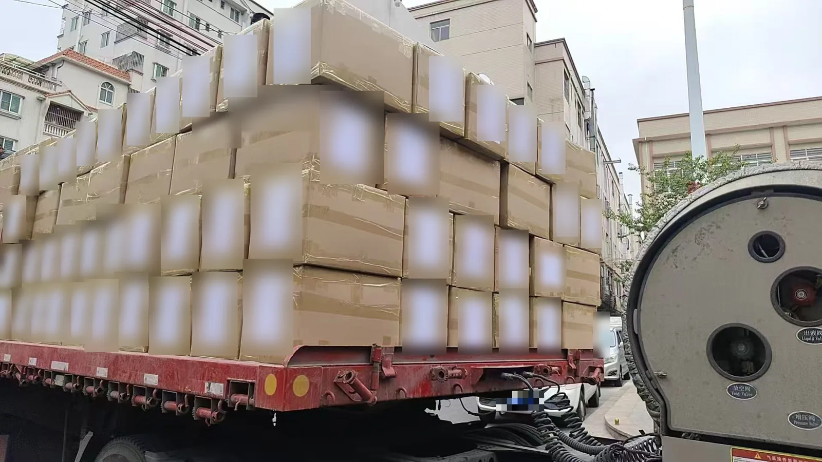Export knitwear cartons stacked and taped on a flatbed trailer before dispatch