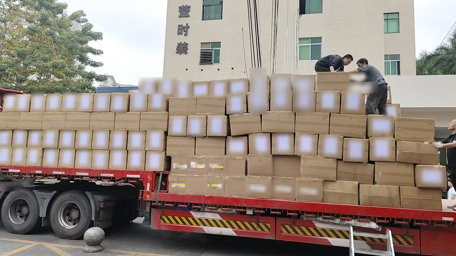 Factory team loading export sweater cartons onto a flatbed truck at CN Sweaters, Dongguan