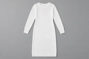 Plain white long-sleeved knitted dress on a neutral gray surface