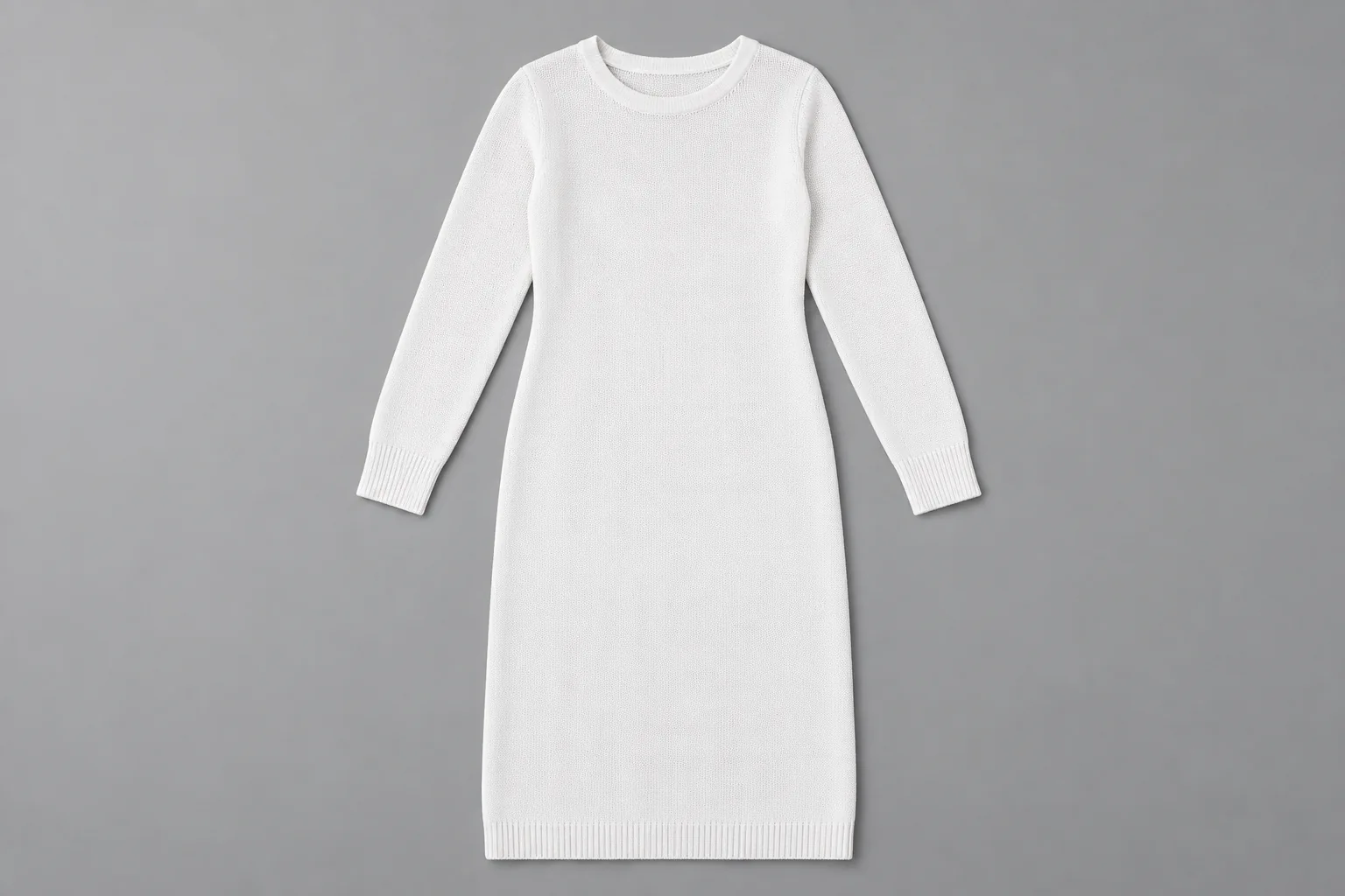 Plain white long-sleeved knitted dress on a neutral gray surface