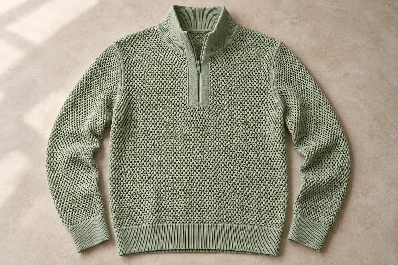 Sage open-knit quarter-zip sweater with a solid placket, collar and cuffs