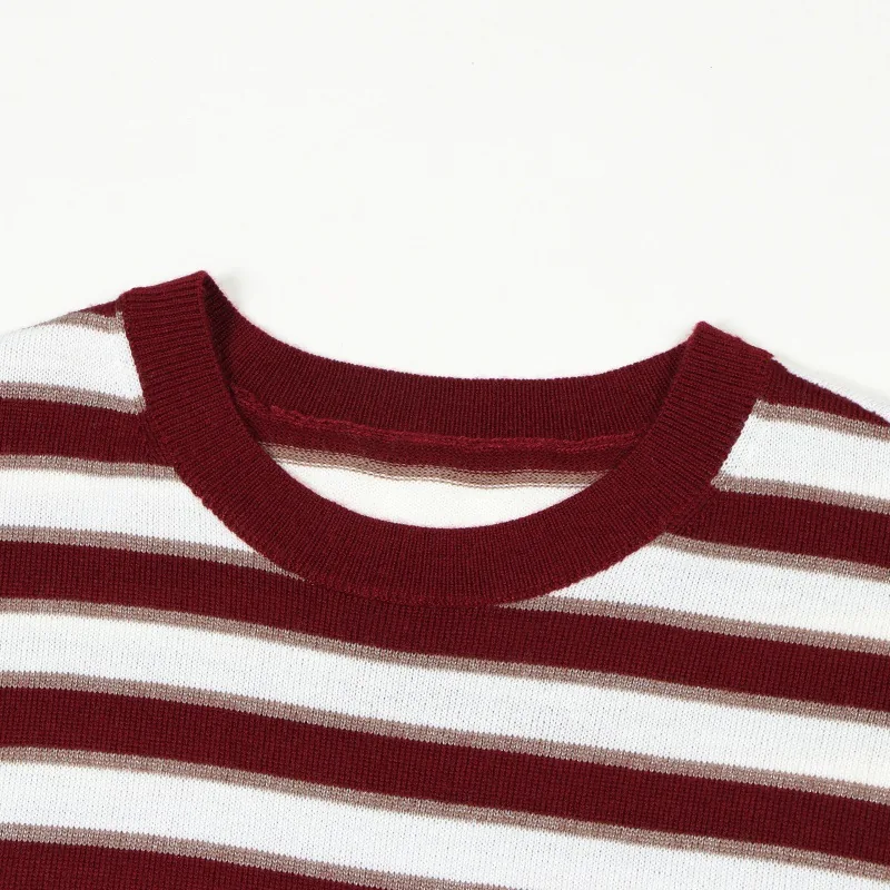 Striped crewneck sweater showing the ribbed neckline in a flat lay